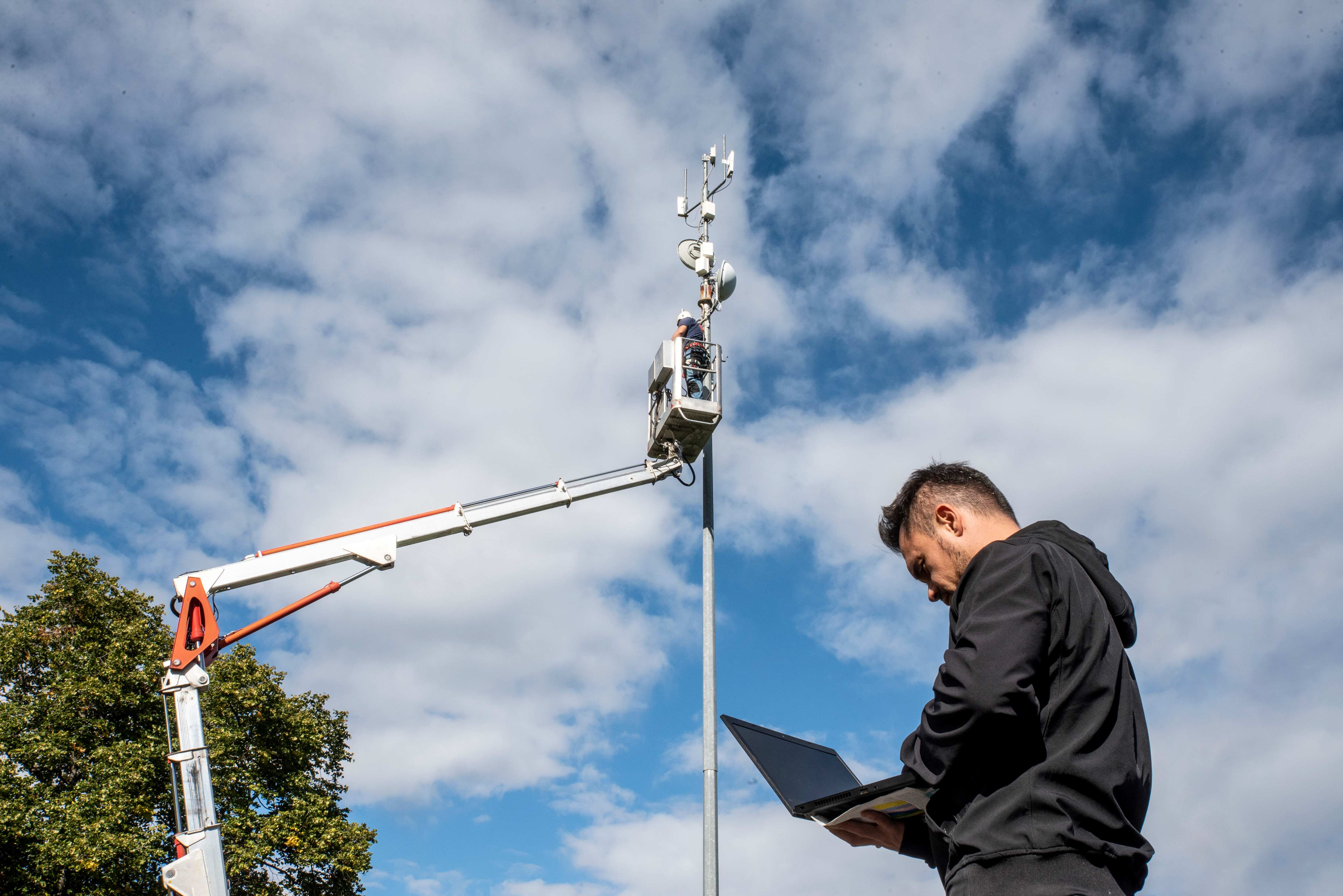 engineers working on 5G tower